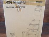 the box of a slow juicer is sitting on a wooden floor