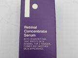 a bottle of retinoal concentrate serum on a white surface