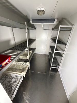 a small room with shelves and shelves in it