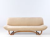 an image of a couch with a curved back and a wooden frame