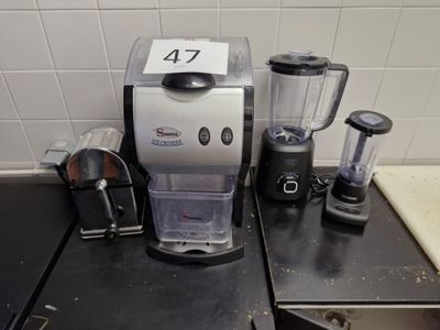 a coffee maker and blender sitting on a kitchen counter