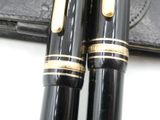 two pens sitting next to each other on a table