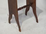 a small table with a wooden top on a white surface
