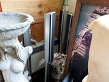 a statue of a woman sitting on a chair next to a mirror