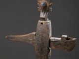 an image of a wooden sculpture of a bird on a stand