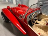 a red car parked inside of a storage unit