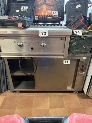 a person ' s feet on the floor in front of a stove