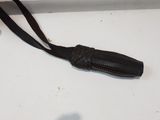 a small black object on the table next to a cell phone