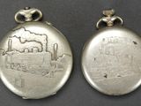 two silver lockes with a picture of a factory on them