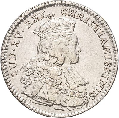 a close up of a silver coin with a crown on it