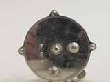 a small silver object on a white surface