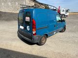 a blue van that is parked in a parking lot