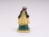 a figurine of a woman in a yellow dress