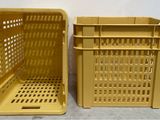 two yellow plastic crates sitting next to each other on a table