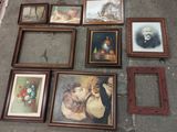 many framed pictures on the floor of this room