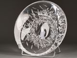 a glass plate with a design on it on a stand