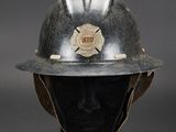 an old fireman ' s helmet on a mannequin head