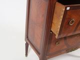 a small chest of drawers with a mirror on top of it