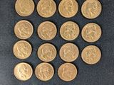 a close up of a pile of gold coins on a black surface