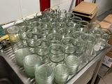 many empty glasses sitting on a table in the kitchen