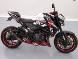 a picture of a red and black motorcycle parked in a room