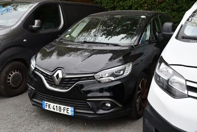 two cars parked next to each other in a parking lot