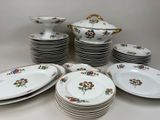 a lot of plates and bowls on the table