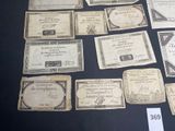 some old paper money sitting on top of a table with a price tag