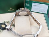 a rolex watch in a box on a table