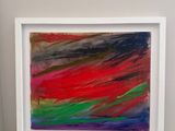 abstract painting in a white frame on a white surface