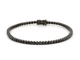 a black diamond tennis bracelet on a white background