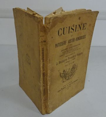 an old book sitting on top of a white table next to a white wall