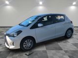 a white toyota yaris parked on a checkered tile floor