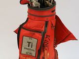 an image of a golf bag filled with golf clubs on a white surface