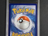 a close up of a pokemon card on a black surface