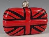red and black purse with a skull on top of it