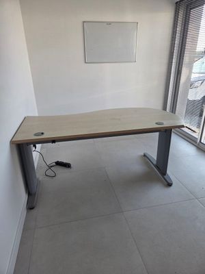 a desk in the corner of a room with a sliding glass door