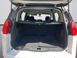 the back of a white car with the trunk open
