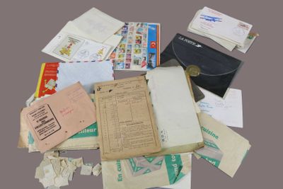 a pile of papers and envelopes sitting on a table
