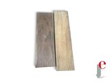 two pieces of wood sitting next to each other on a white surface