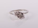 a white gold ring with a cluster of diamonds
