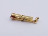 a gold plated metal object on a white surface