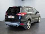 the rear end of a black ford kuga parked in a showroom