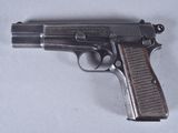 a gun that is laying on a white surface
