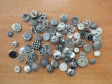 a pile of buttons on a wooden table