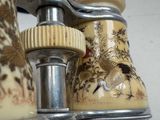 a close up of a vase with a bird on it
