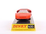 a red toy car sitting on top of a yellow box