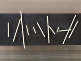 a close up of a display case with sticks in it