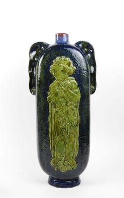 a blue vase with a green design on it