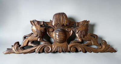 a wood carving of a woman and two dogs